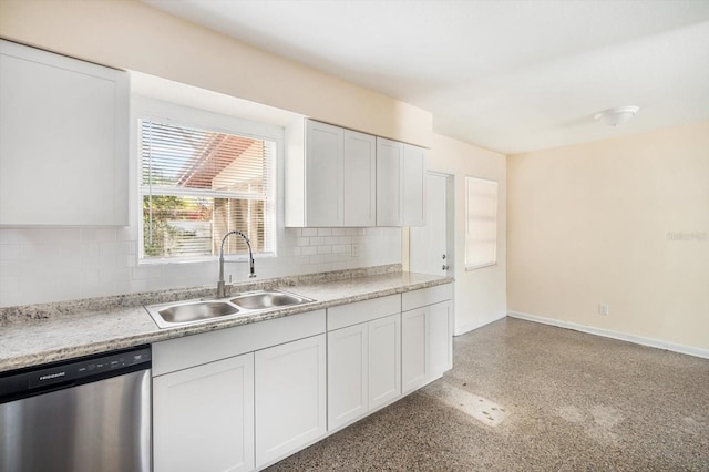 kitchen featuring backsplash, baseboards, dishwasher, light countertops, and a sink