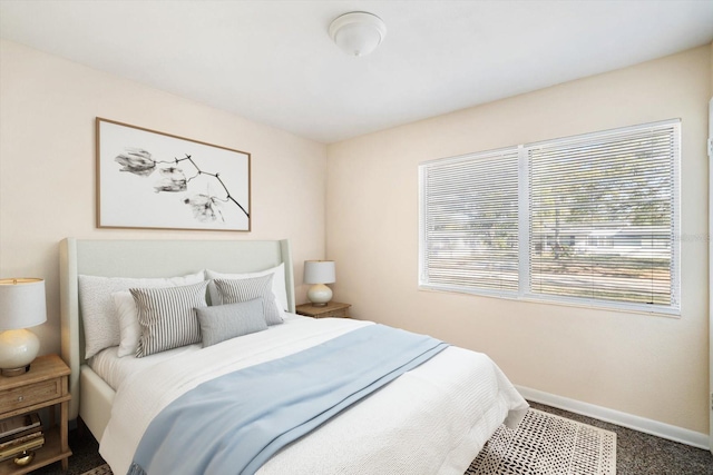 carpeted bedroom featuring baseboards