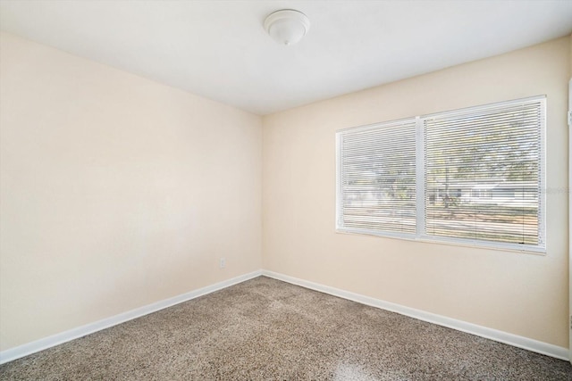 empty room featuring baseboards