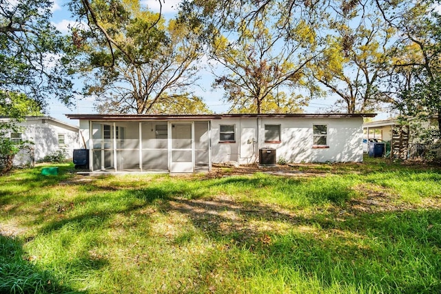 back of house with a yard, central AC unit, and a sunroom