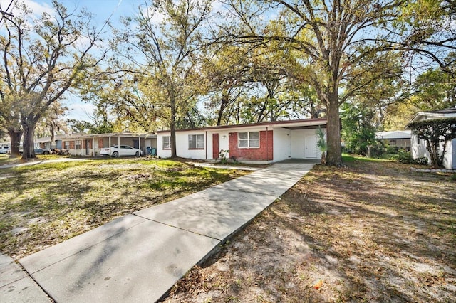 ranch-style home featuring a carport and driveway