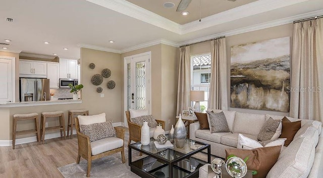 living area with light wood finished floors, recessed lighting, crown molding, and baseboards