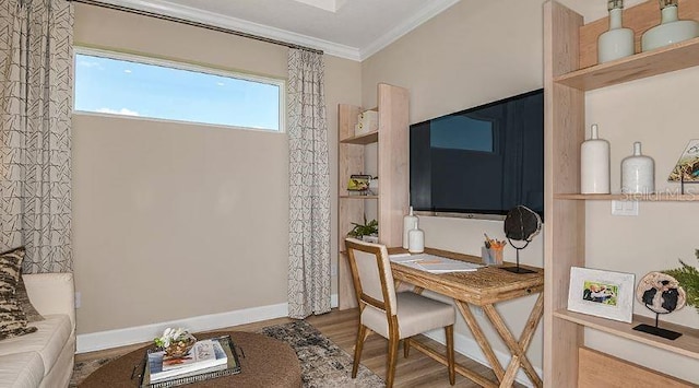 office space featuring crown molding, wood finished floors, and baseboards