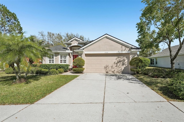 view of front of property with stucco siding, driveway, a front yard, and a garage