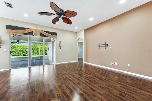 unfurnished living room featuring baseboards, ceiling fan, recessed lighting, wood finished floors, and arched walkways