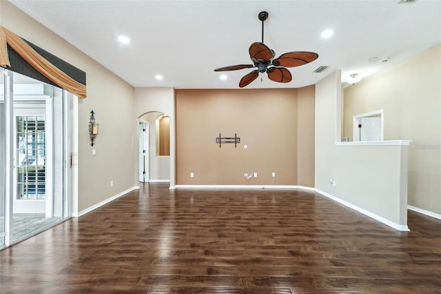 unfurnished living room featuring recessed lighting, arched walkways, dark wood finished floors, and a ceiling fan