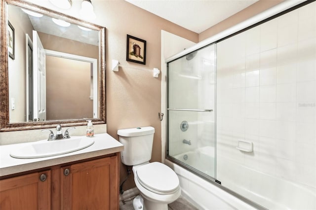 full bath with enclosed tub / shower combo, toilet, vanity, and a textured wall