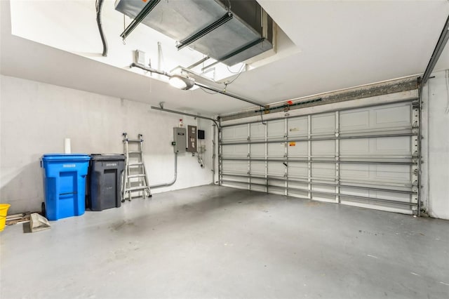 garage with electric panel and a garage door opener