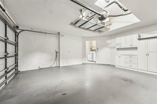 garage featuring washer and clothes dryer and a garage door opener