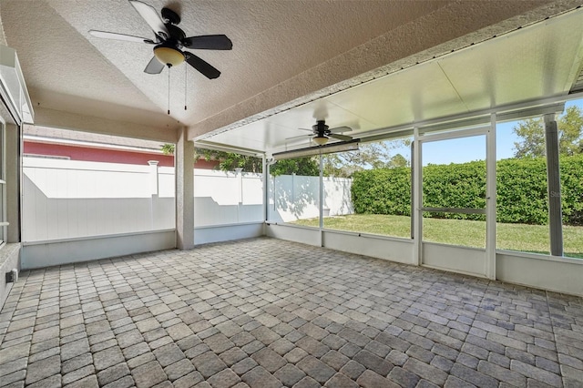 unfurnished sunroom featuring plenty of natural light and ceiling fan