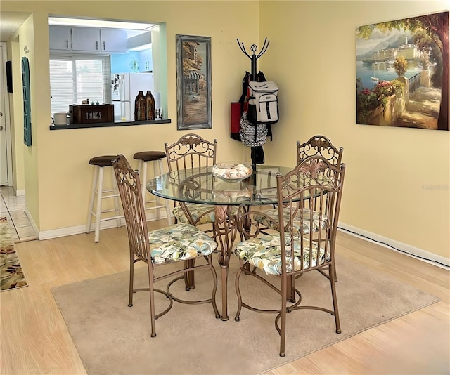 dining area featuring wood finished floors and baseboards