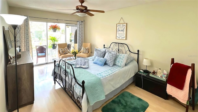 bedroom featuring access to exterior and a ceiling fan