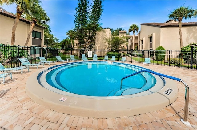 view of pool with a fenced in pool, a patio, and fence
