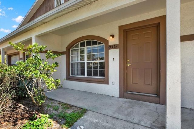 view of exterior entry with stucco siding