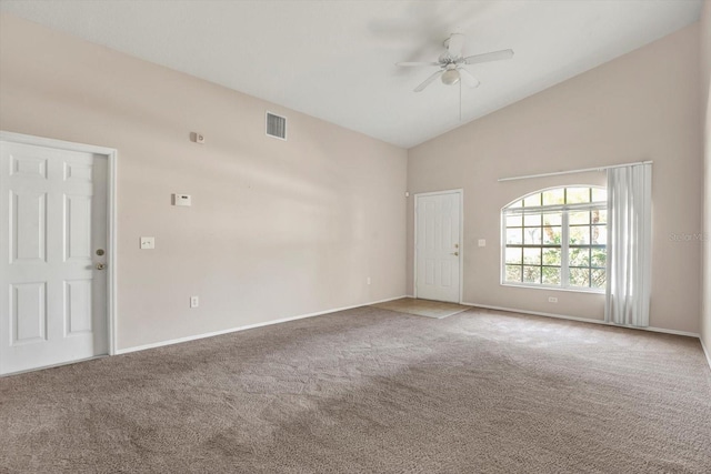 carpeted spare room featuring baseboards, a ceiling fan, visible vents, and high vaulted ceiling