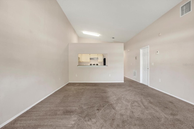 interior space featuring visible vents, high vaulted ceiling, and baseboards