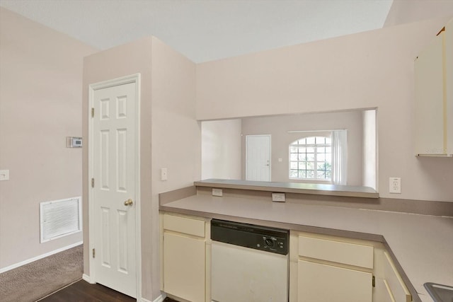 kitchen with visible vents, dishwasher, cream cabinets, and light countertops