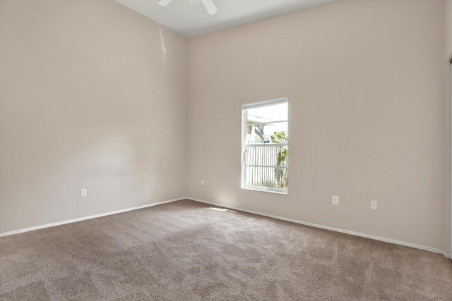 unfurnished room with carpet flooring, baseboards, and ceiling fan