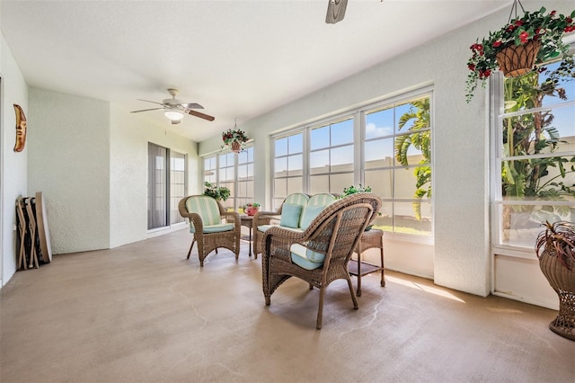 sunroom featuring a wealth of natural light and ceiling fan