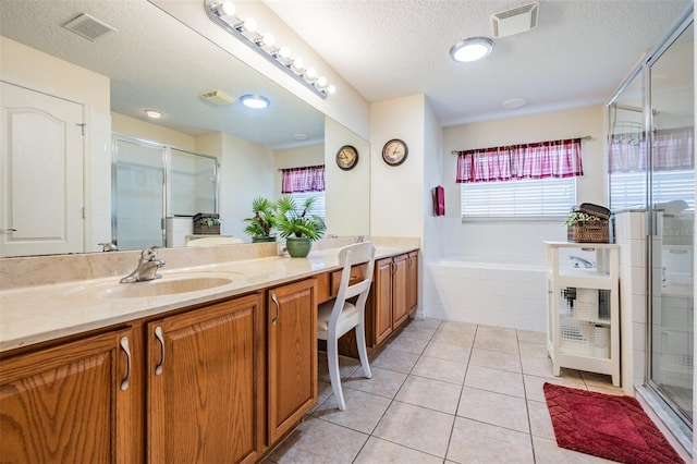 full bathroom with tile patterned floors, visible vents, a shower stall, and a sink