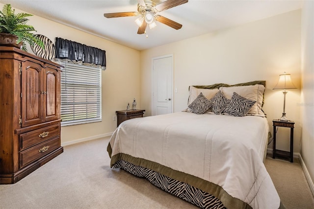 bedroom with baseboards, light colored carpet, and a ceiling fan