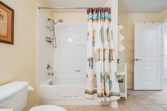 bathroom featuring a textured ceiling, toilet, shower / tub combo, and tile patterned flooring