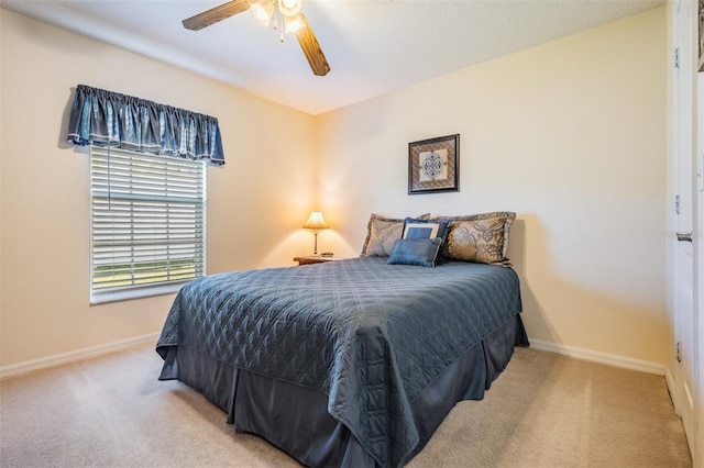 bedroom featuring baseboards, ceiling fan, and carpet flooring