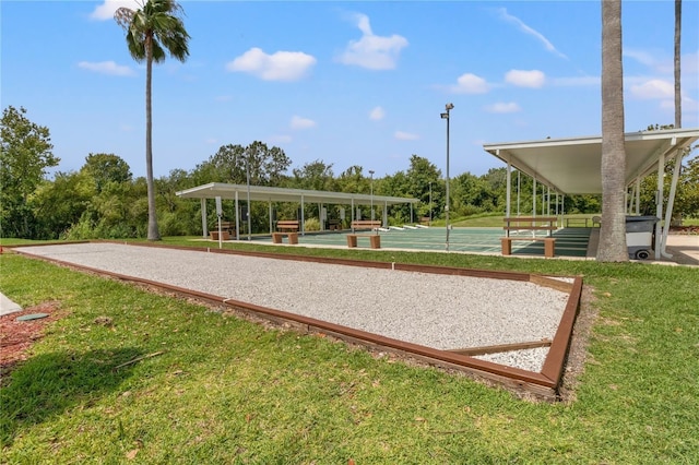 surrounding community with a yard and shuffleboard