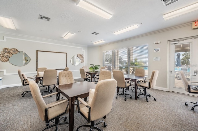 office space with crown molding, carpet, and visible vents