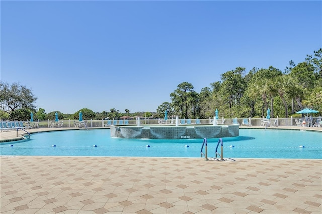 pool featuring a patio and fence