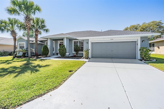 view of front of home featuring stucco siding, an attached garage, and a front yard