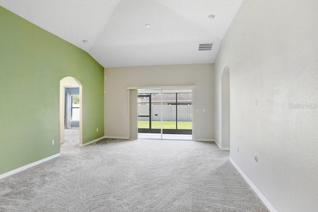 spare room featuring baseboards, visible vents, arched walkways, and a healthy amount of sunlight