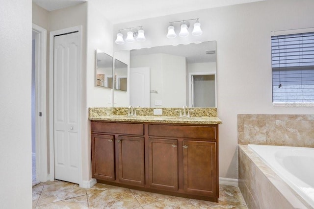 bathroom with double vanity, a closet, a garden tub, and a sink