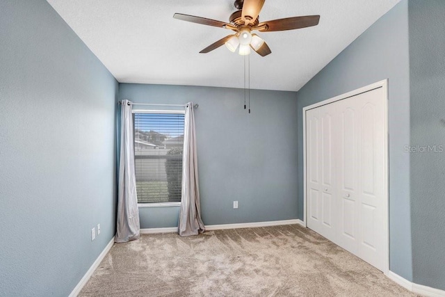 unfurnished bedroom featuring a closet, ceiling fan, baseboards, and carpet floors