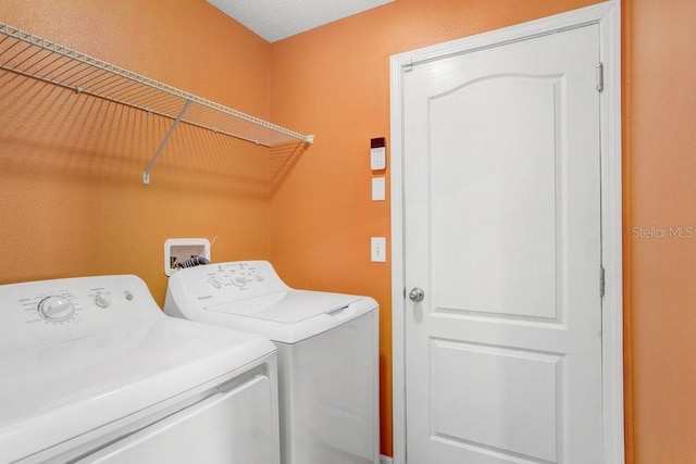 laundry room with laundry area and washing machine and clothes dryer