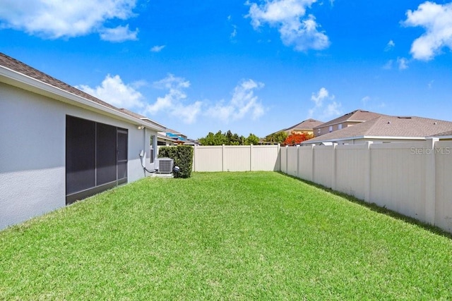 view of yard featuring cooling unit and fence