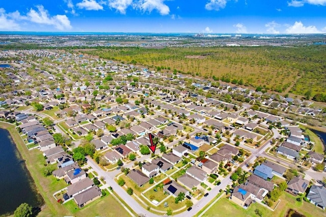 drone / aerial view with a residential view and a water view