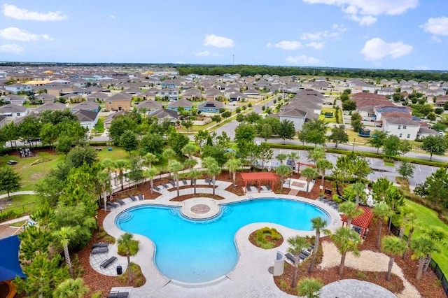 pool with a patio area and a residential view