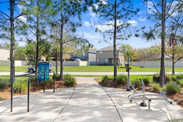 exterior space featuring a yard, fence, and a residential view