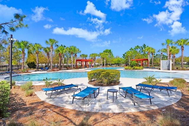 pool featuring fence, a patio area, and a pergola