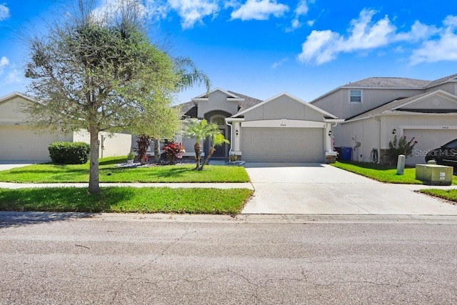 view of front of home with a garage, a front yard, and driveway