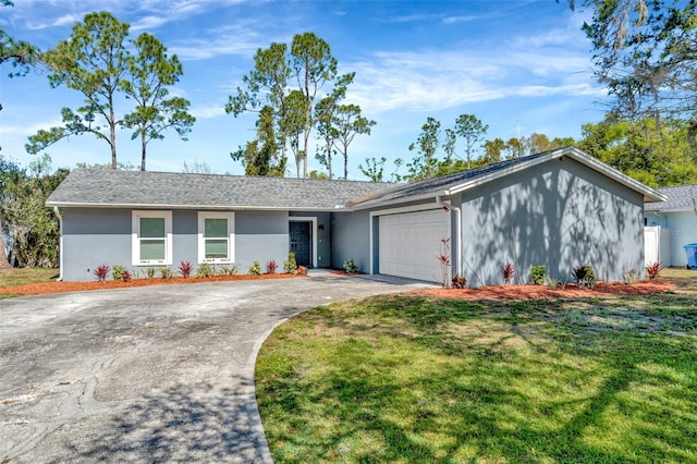 view of front of house featuring stucco siding, an attached garage, driveway, and a front lawn