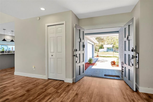 entryway featuring recessed lighting, baseboards, and wood finished floors