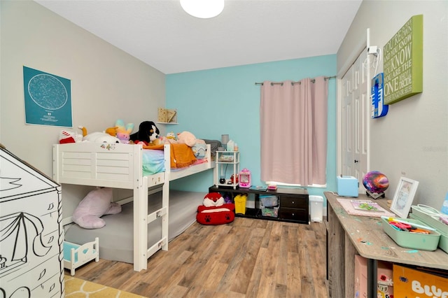 bedroom featuring wood finished floors and a closet