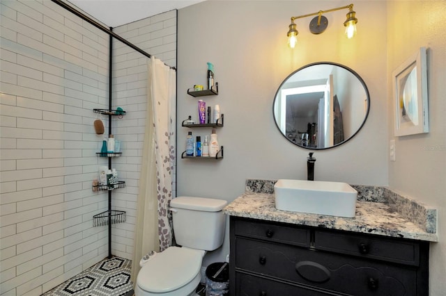 bathroom featuring vanity, toilet, and tiled shower