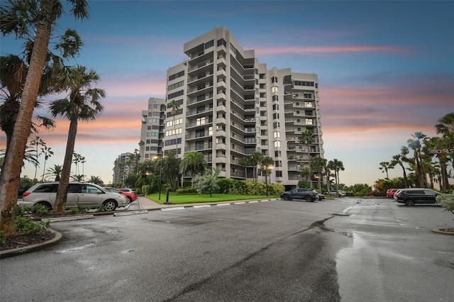 property at dusk featuring uncovered parking