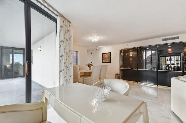 dining room featuring visible vents and marble finish floor