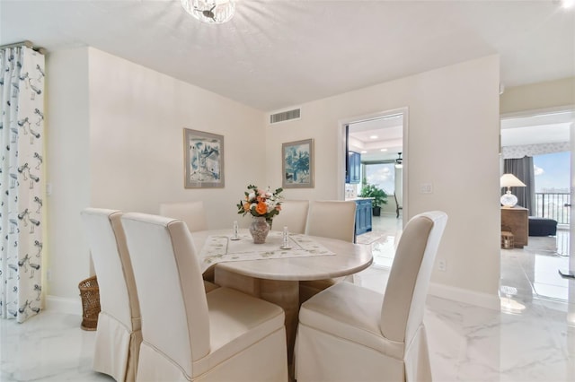 dining room with baseboards, visible vents, and marble finish floor