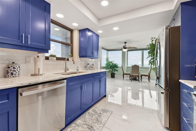 kitchen featuring a sink, stainless steel appliances, marble finish floor, and blue cabinets