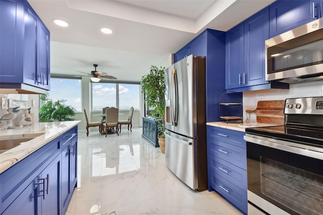 kitchen with blue cabinets, marble finish floor, and stainless steel appliances